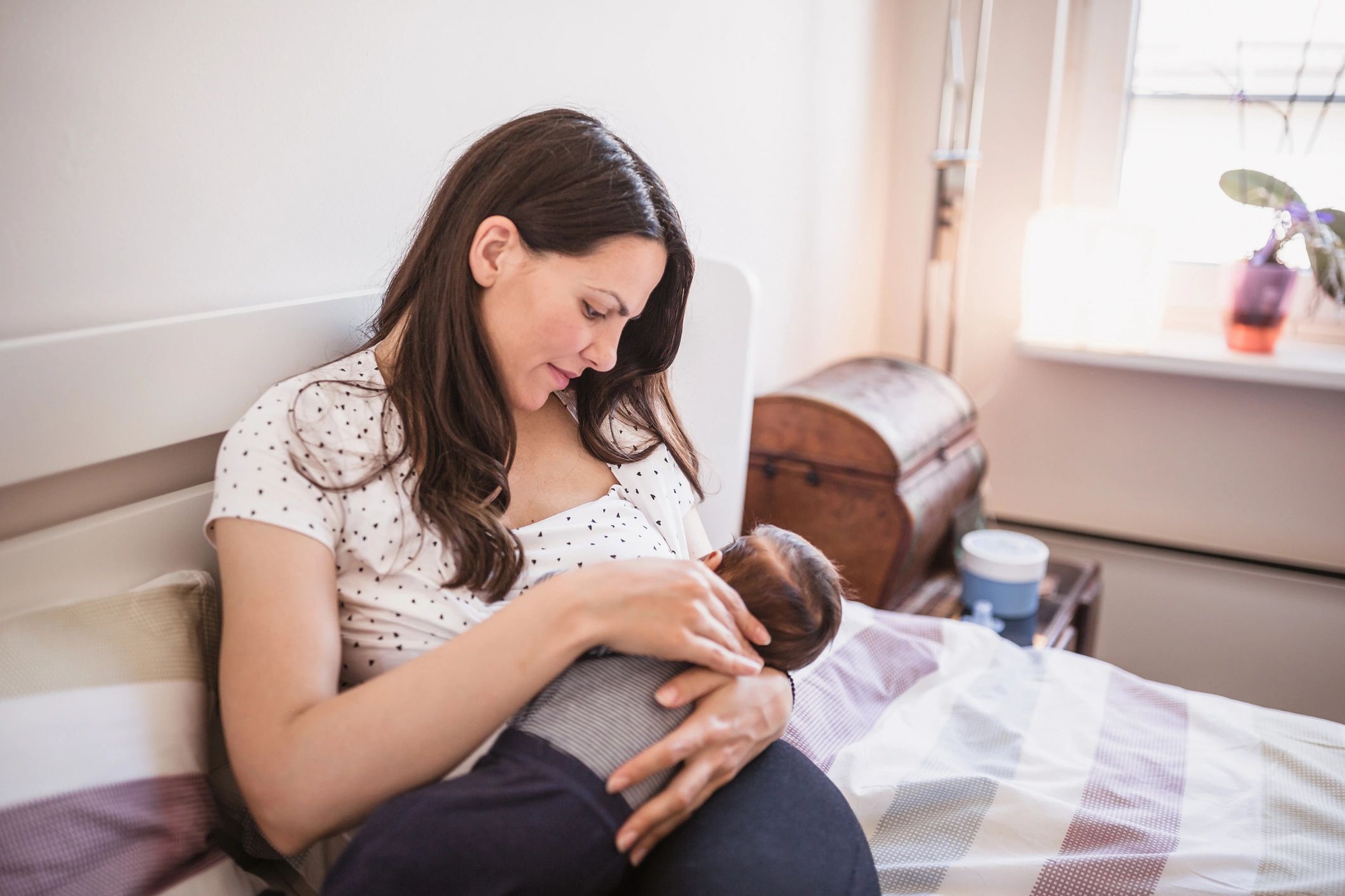 Mother breastfeeding her baby in a calm home setting