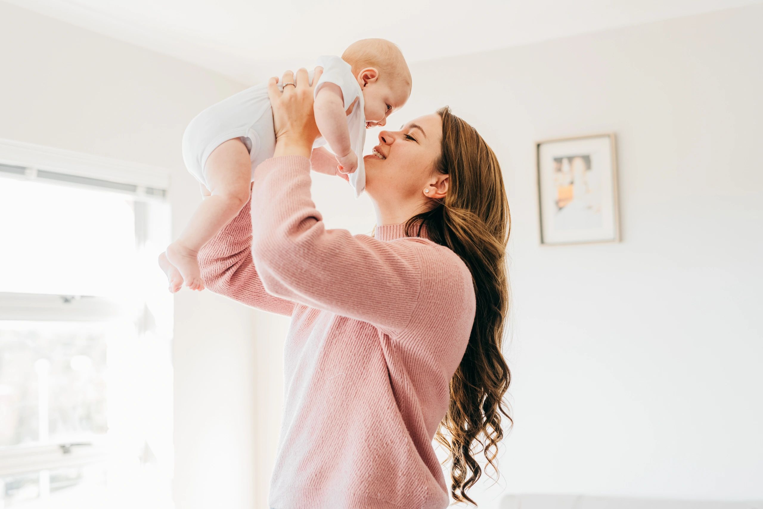 Mother holding her baby close at home