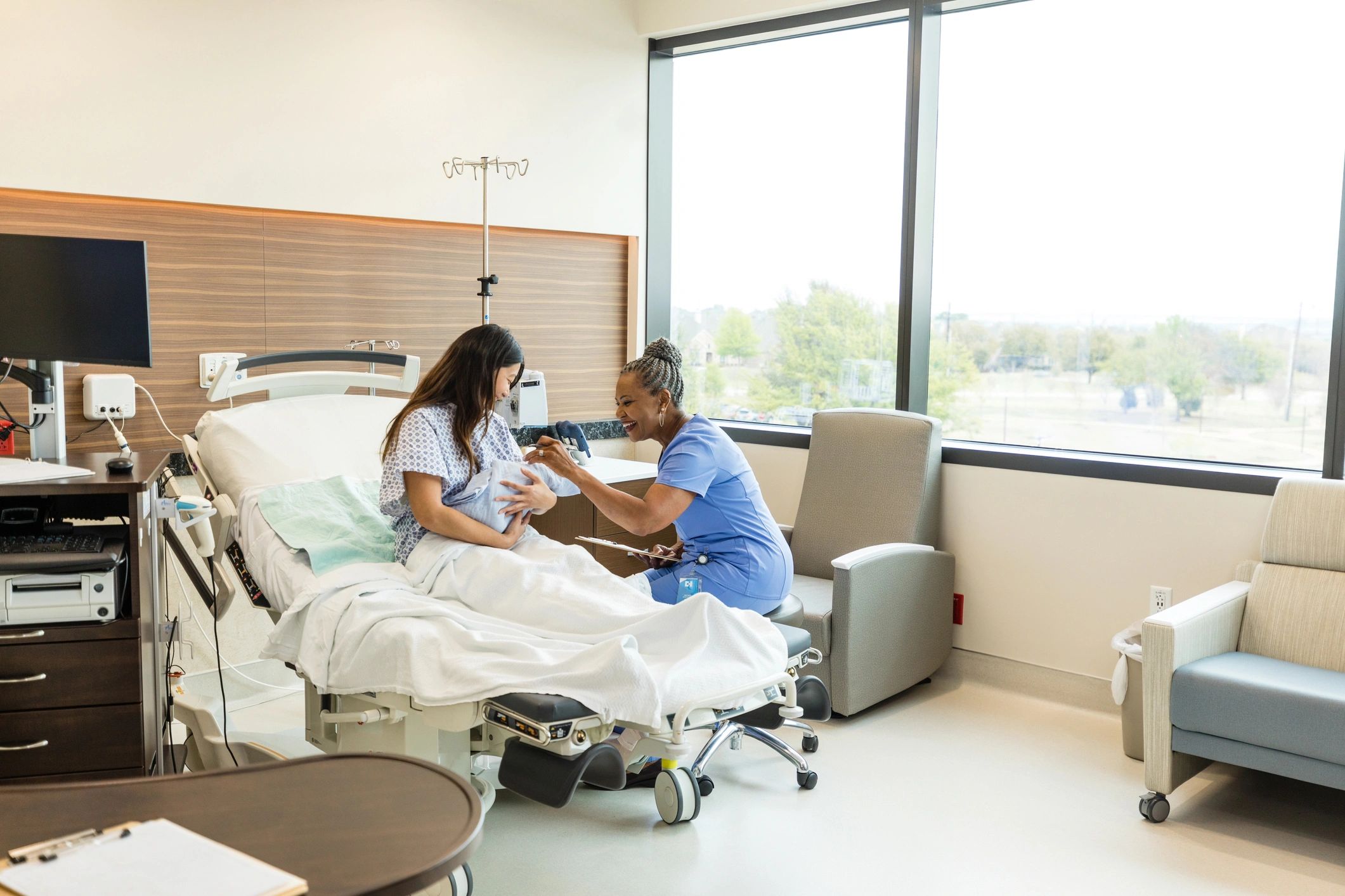 Lactation consultant supporting a mother and newborn