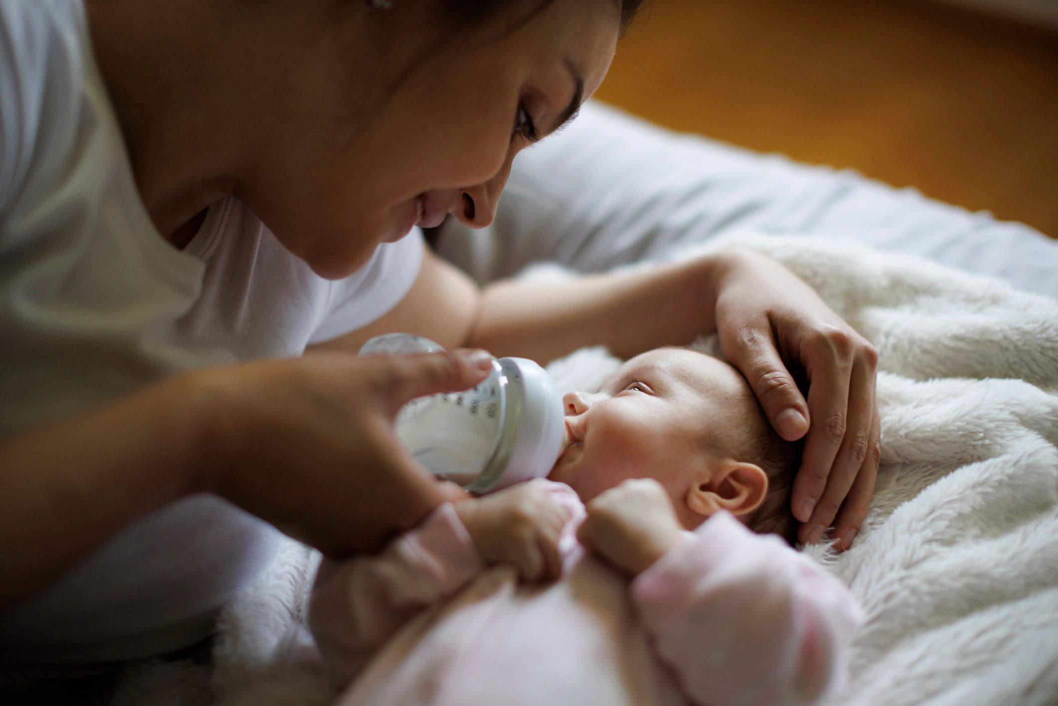 Mother feeding her newborn at home