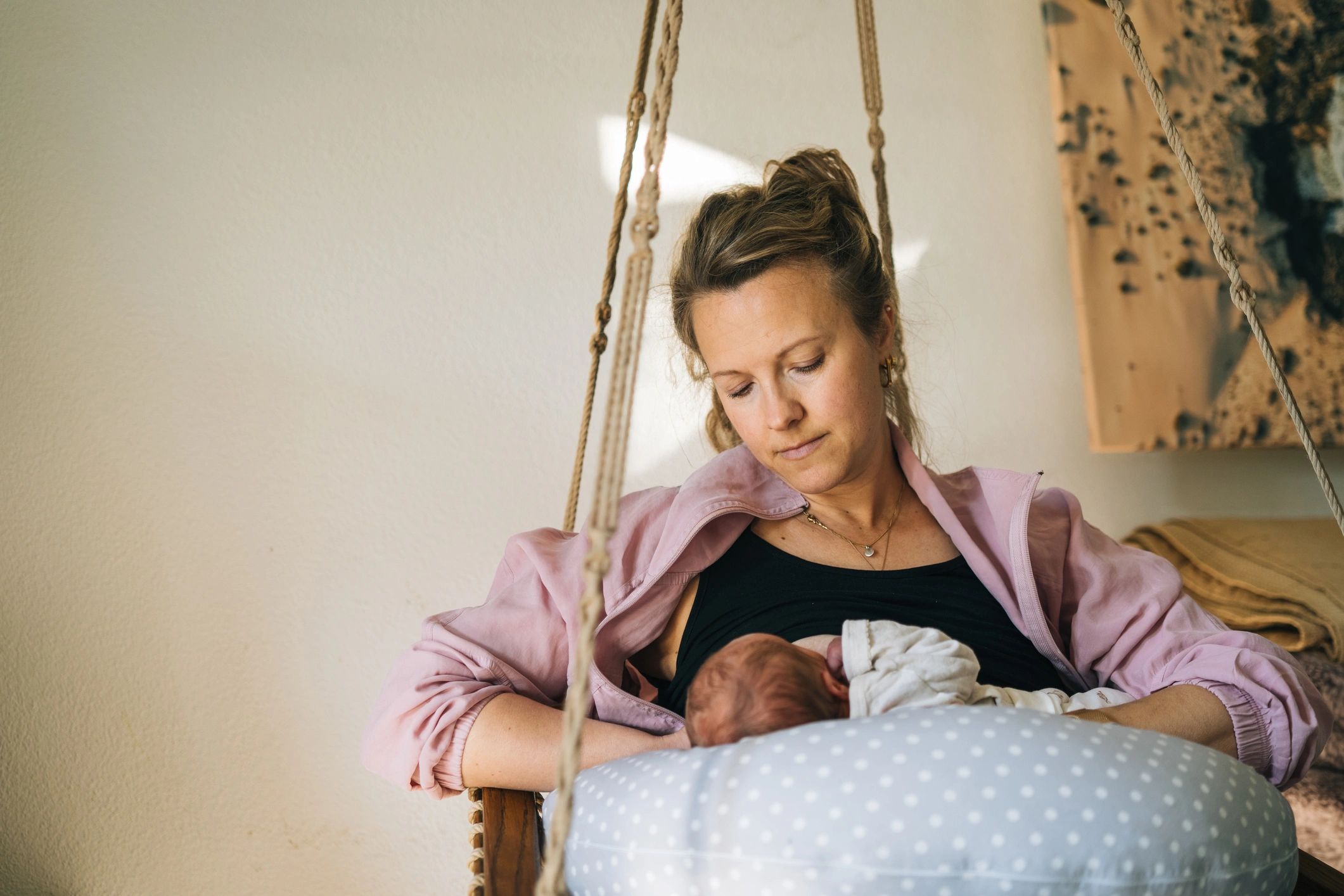 New mother nursing her newborn at home